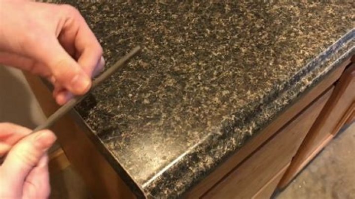 How do you reattach plastic laminate countertop edging?