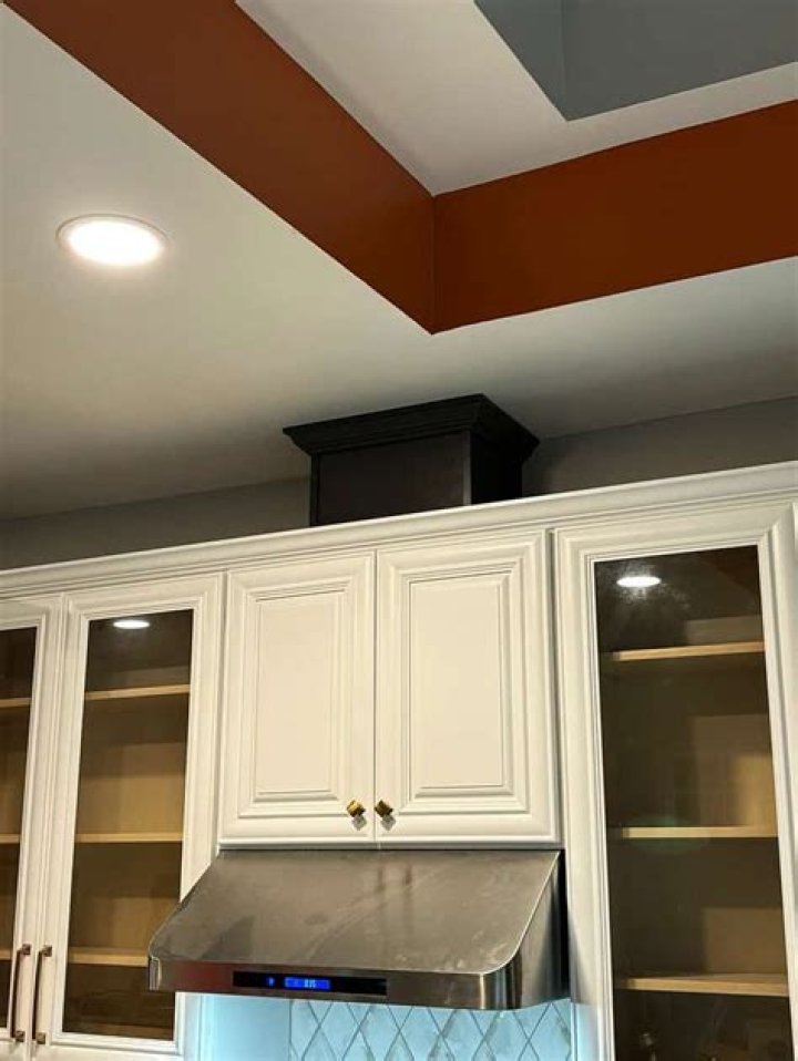 How do you secure kitchen cabinets to the wall?