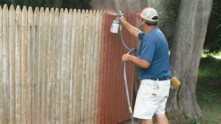 How do you stop overspray when painting a fence?