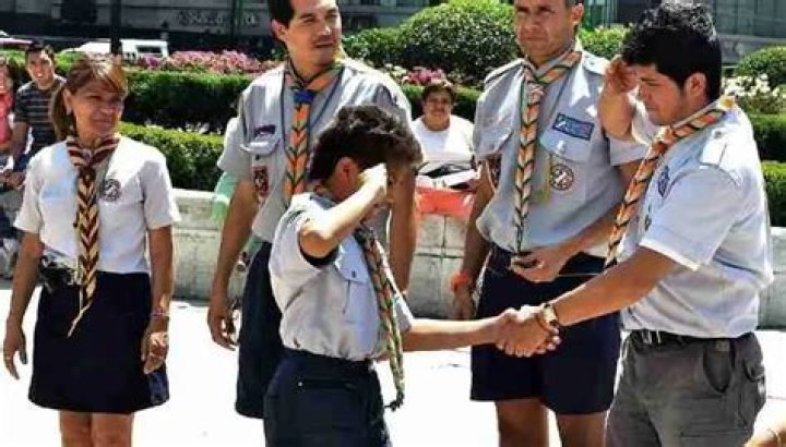 Why do Girl Scouts shake with their left hand?