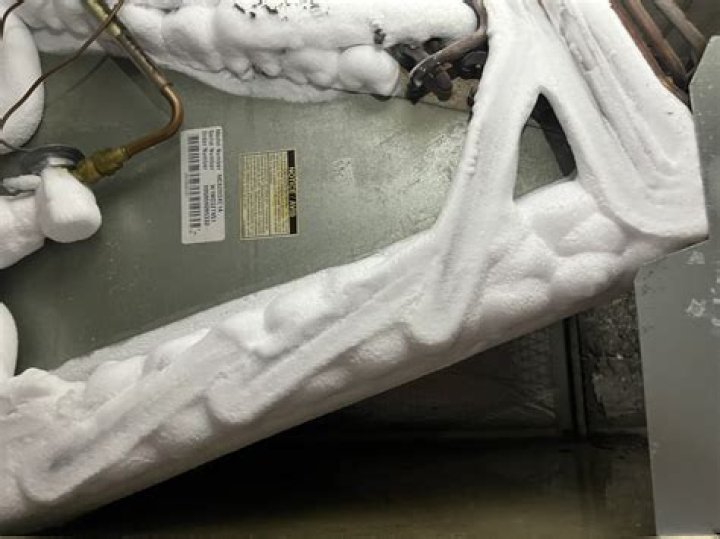 Why does ice form on air conditioner coils?